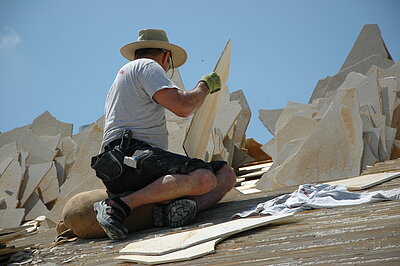 Handwerker beim Decken eines Legschieferdachs