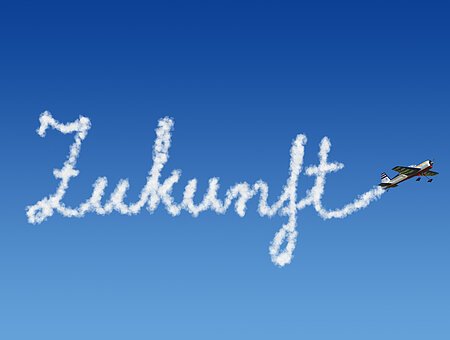 ein kleines Flugzeug schreibt Zukunft in den Himmel