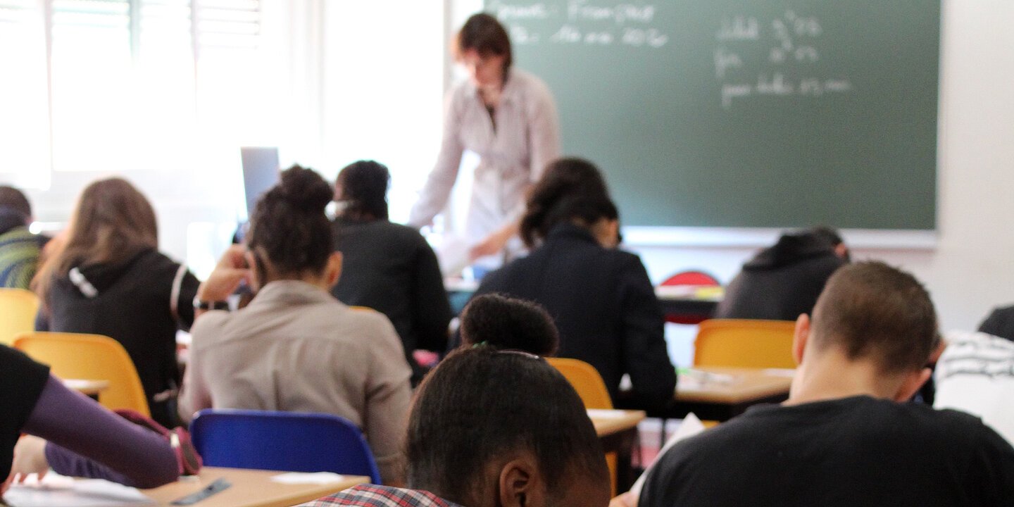 Zu sehen ist eine Klasse, die Dinge aufschreibt.